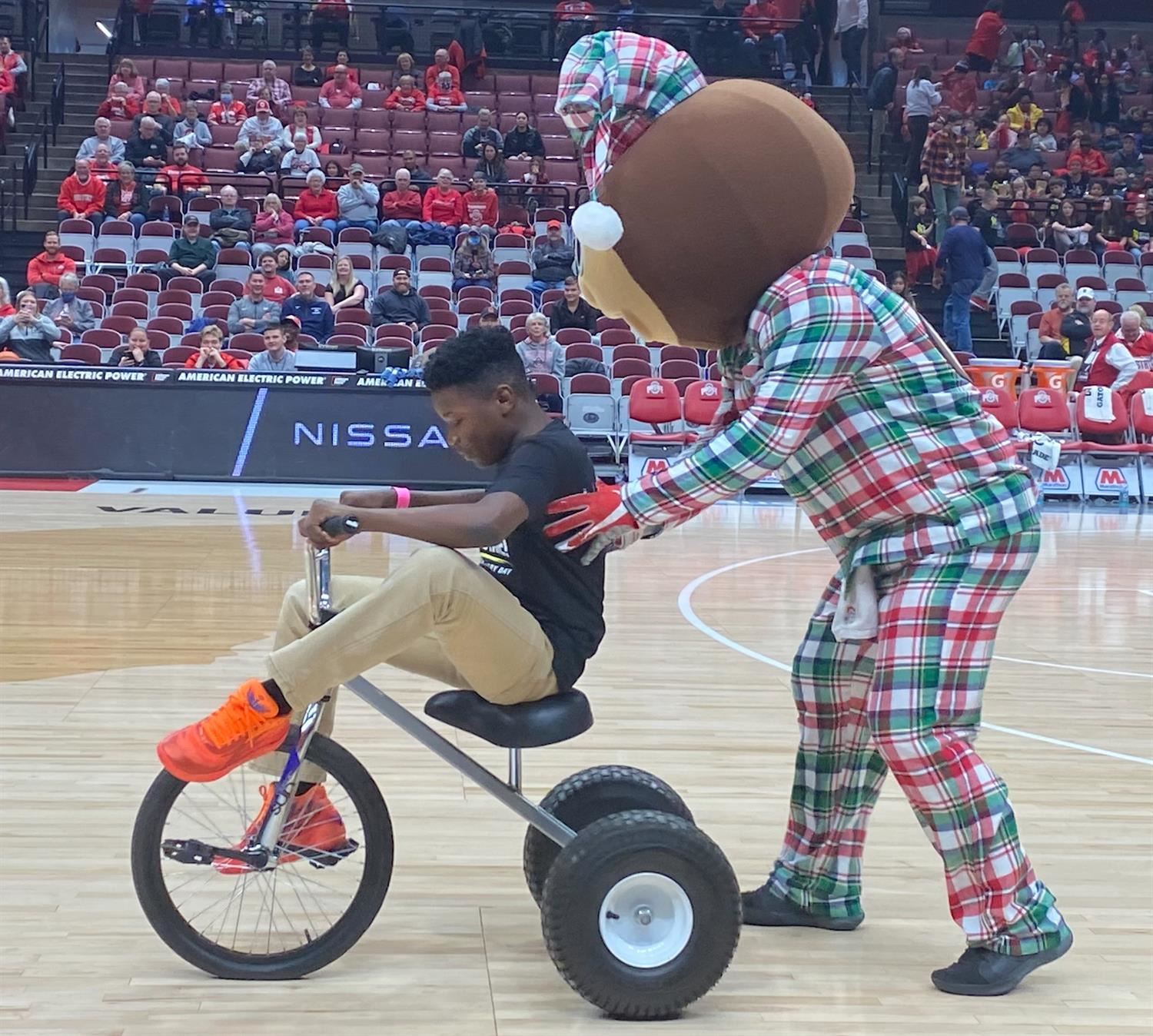 Student being pushed on a tricycle by Brutus